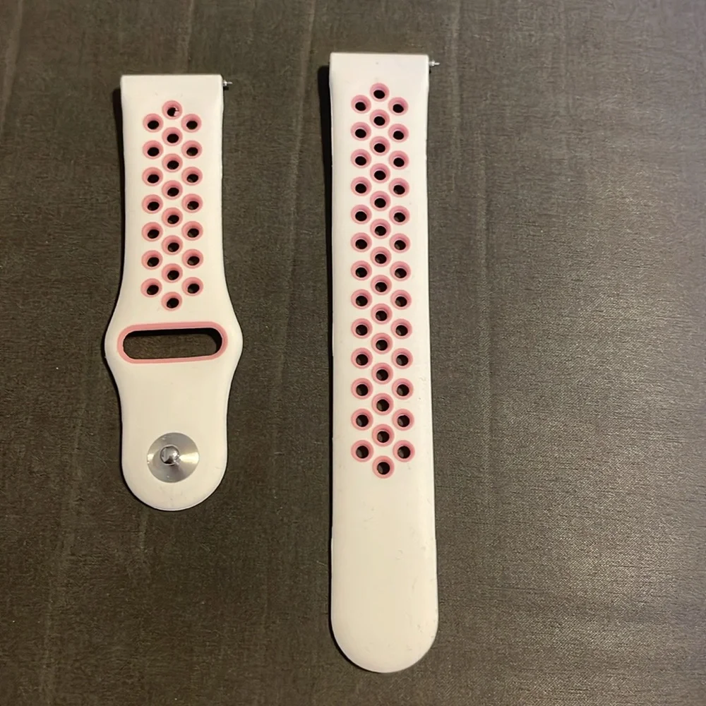 Pink and white Fitbit versa band